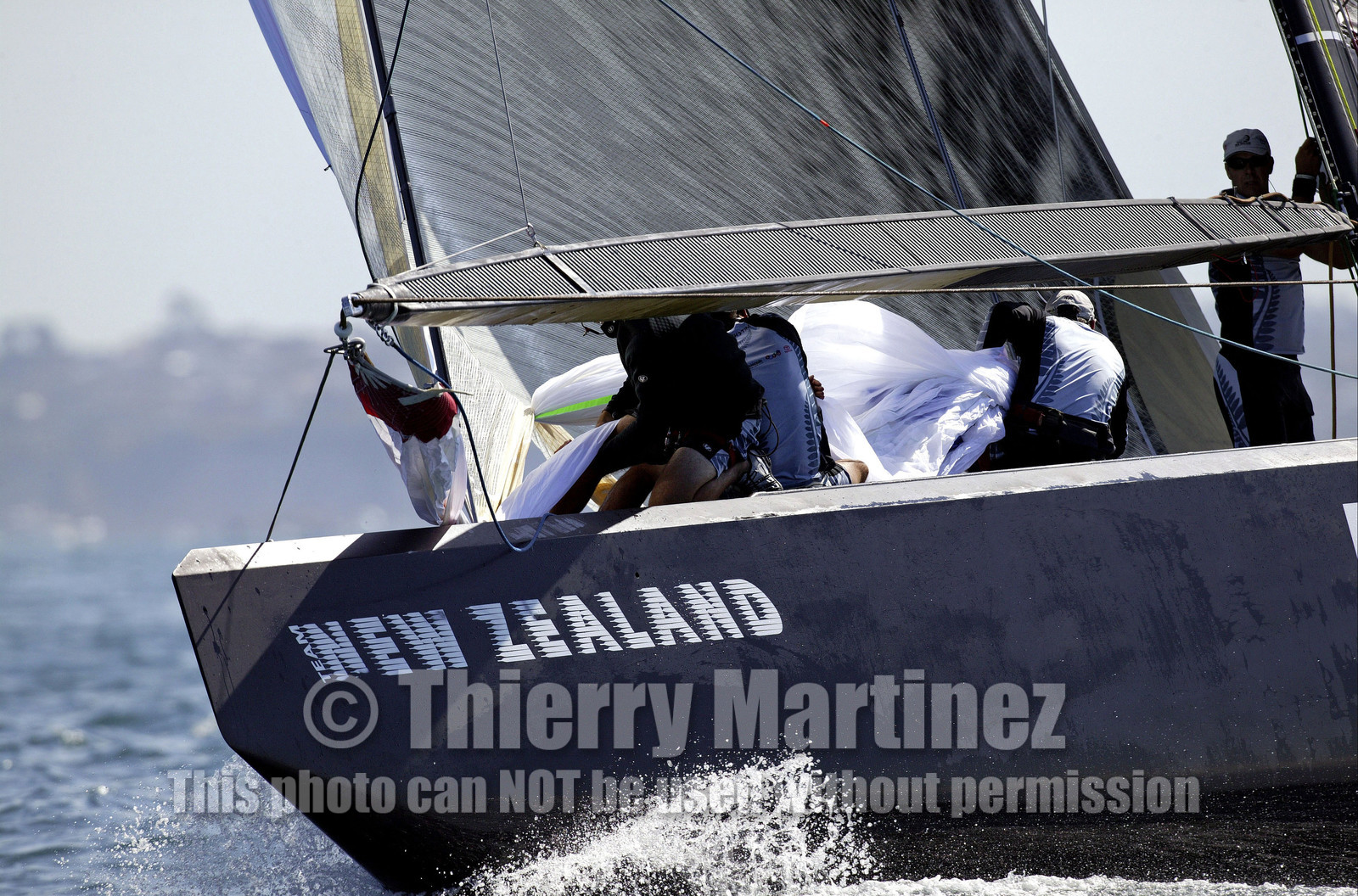 03_0208D ©Th.Martinez - Auckland (NZ) . America's Cup 2003. 18th February 2003. Day 2..Alinghi (SUI 64) vs Team NZ (NZL 82) .Team NZ crew seting up spinnaker at upwind mark...