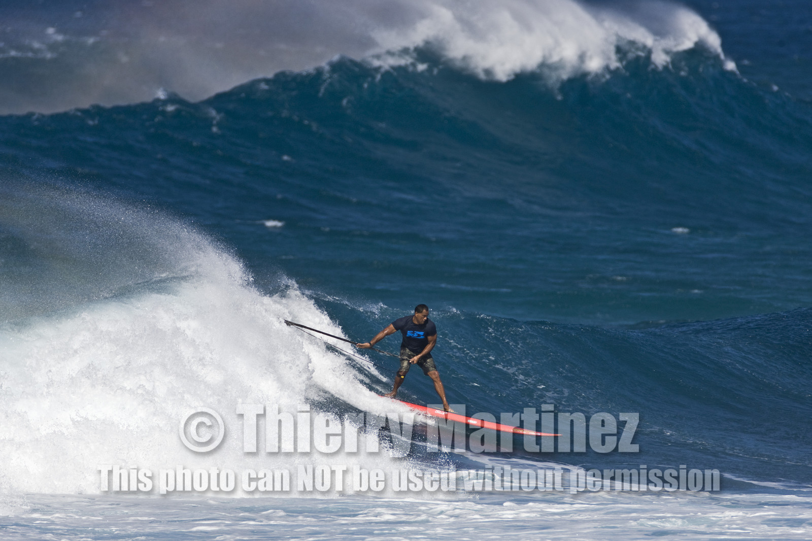 Stand Up Paddle  in waves at Hookip'a Beach - North Shore Maui - Hawaii.