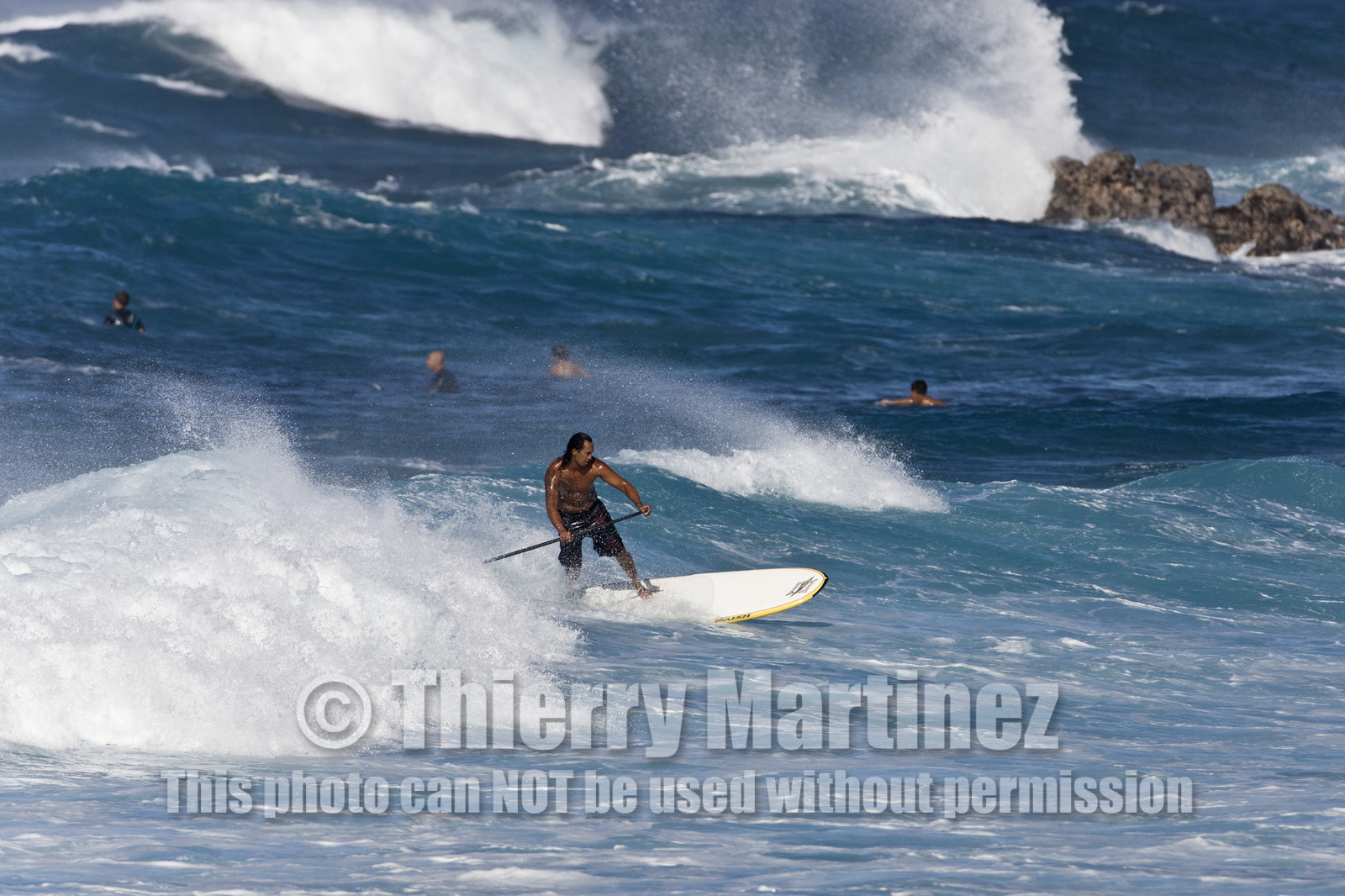 Stand Up Paddle  in waves at Hookip'a Beach - North Shore Maui - Hawaii.