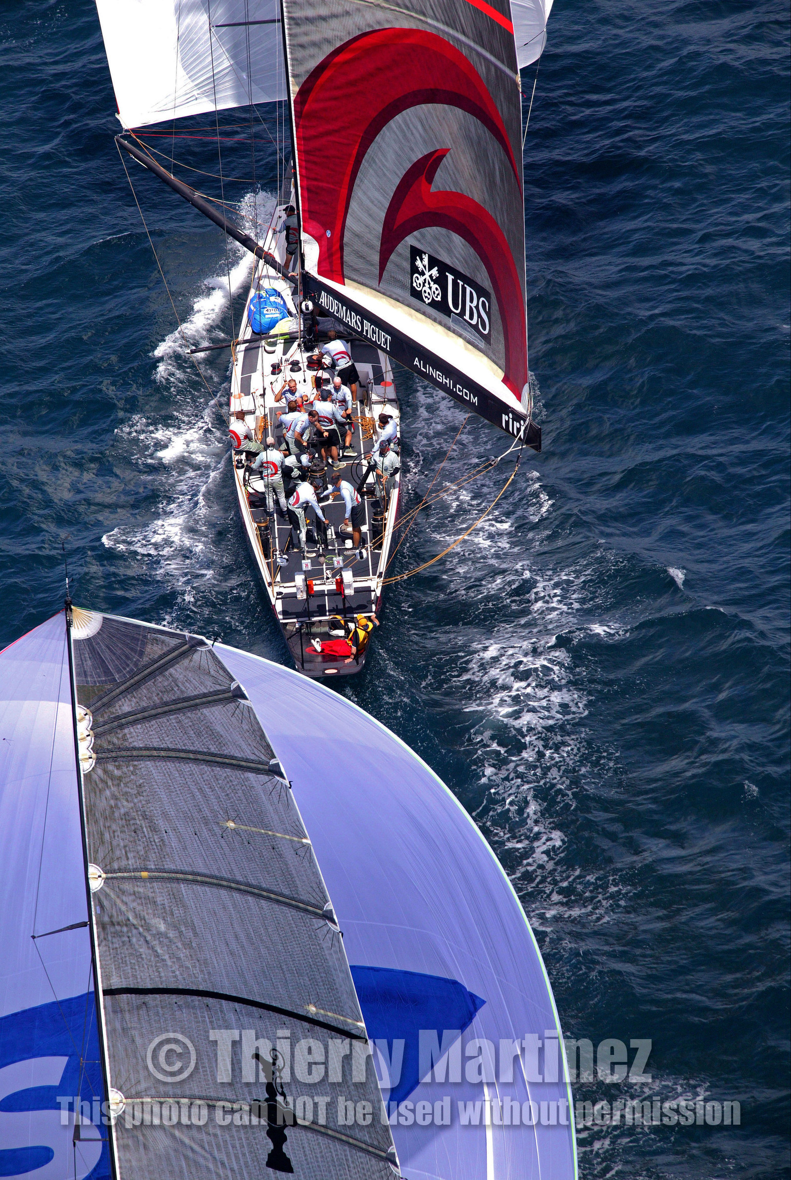 03_0975D © Th.Martinez . Auckland   New Zealand. 18th February 2003 America's Cup 2003, Day 3 Alinghi(SUI64) vs Team New Zealand(NZL82).Alinghi Team leading NZL 82 in last downwind leg.