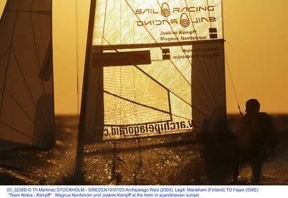 03_3236D  © Th.Martinez,STOCKHOLM - SWEDEN10 07 03-Archipelago Raid (2003). Leg4: Marieham (Finland) TO Fejan (SWE). Team Nokia - Kempff , Magnus Nordstrom and Joakim Kempff at the helm in scandinavian sunset.