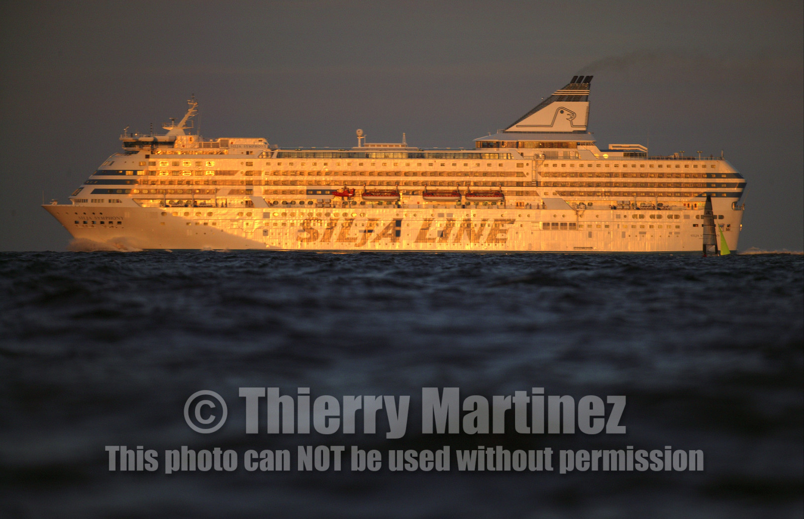 03_3251D © Th.Martinez,STOCKHOLMSWEDEN10 07 03-Archipelago Raid (2003). Leg 4, Marieham (Finland ) to Fejan (Sweden) . Crossing a ferry at sunset.