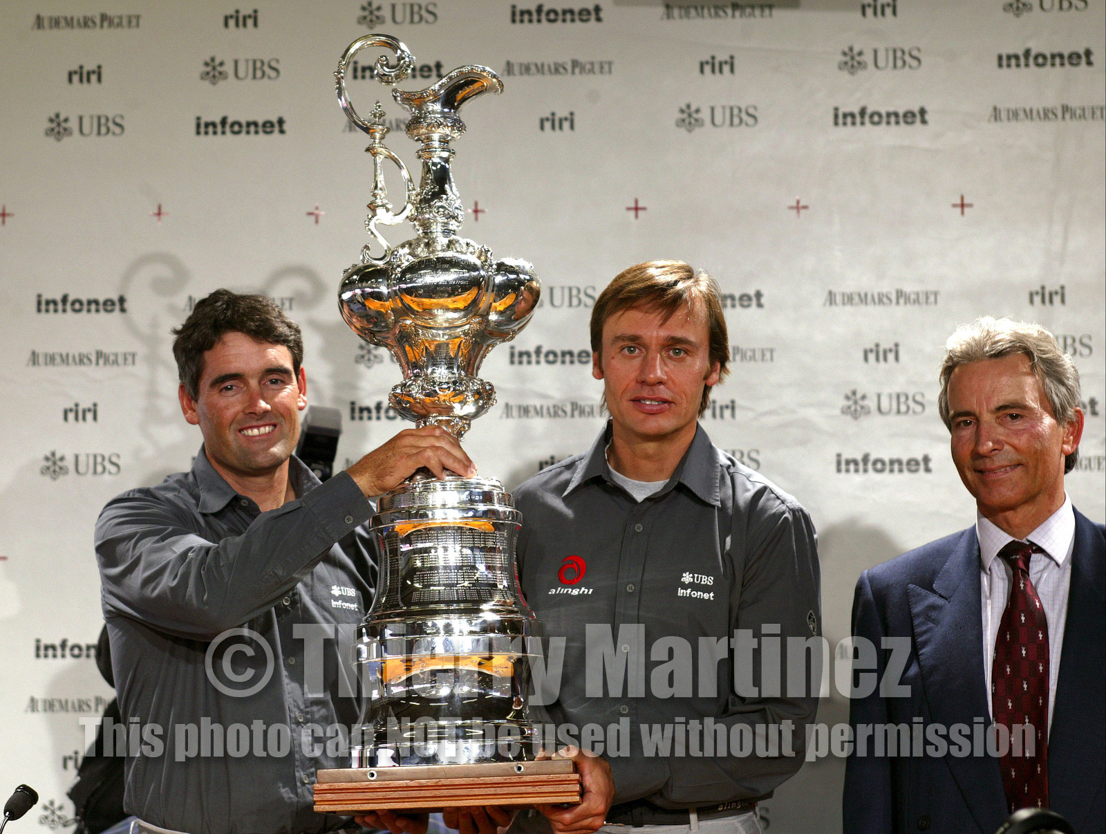 03_2231D ©Th.Martinez .Geneva , Switzerland. America's Cup 2003. 8th March 2003.Alinghi Team winner of America's Cup 2003, arriving in Geneva Airport with thE America's Cup..Russell Coutts (Alinghi's skipper) and Ernesto Bertarelli, holding the America's cup , next to SNG commodore Pierre Yves Firminich...