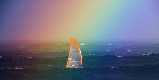 07_00208 ©ThMartinez. MAUI, HAWAII - USA, 6 January  2007 . .Sailing in the rainbow, a windsurfer in waves at Ho'okipa beach, North Shore of Maui Island (Hawaii-USA), as it's raining ...