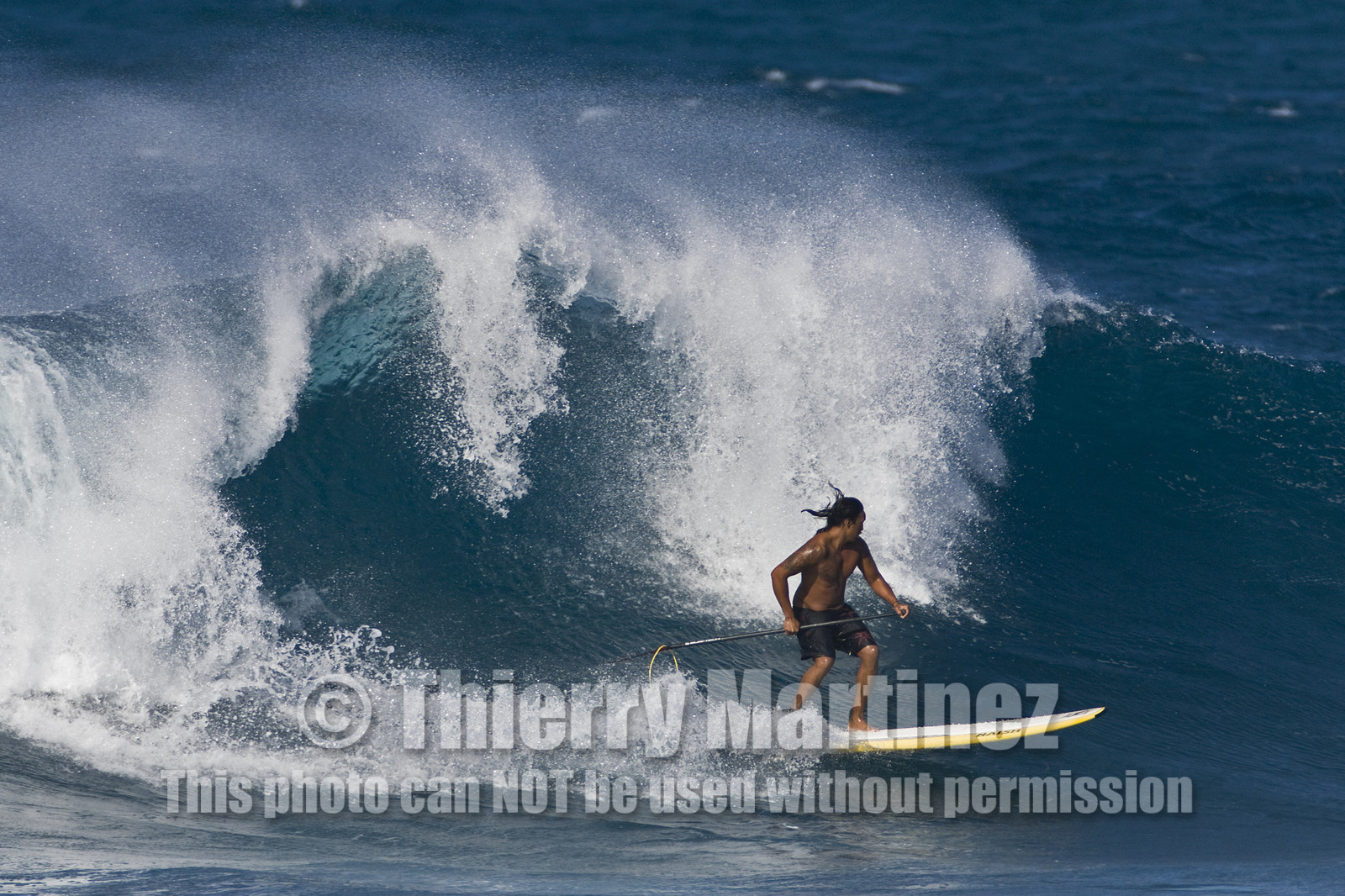 Stand Up Paddle  in waves at Hookip'a Beach - North Shore Maui - Hawaii.