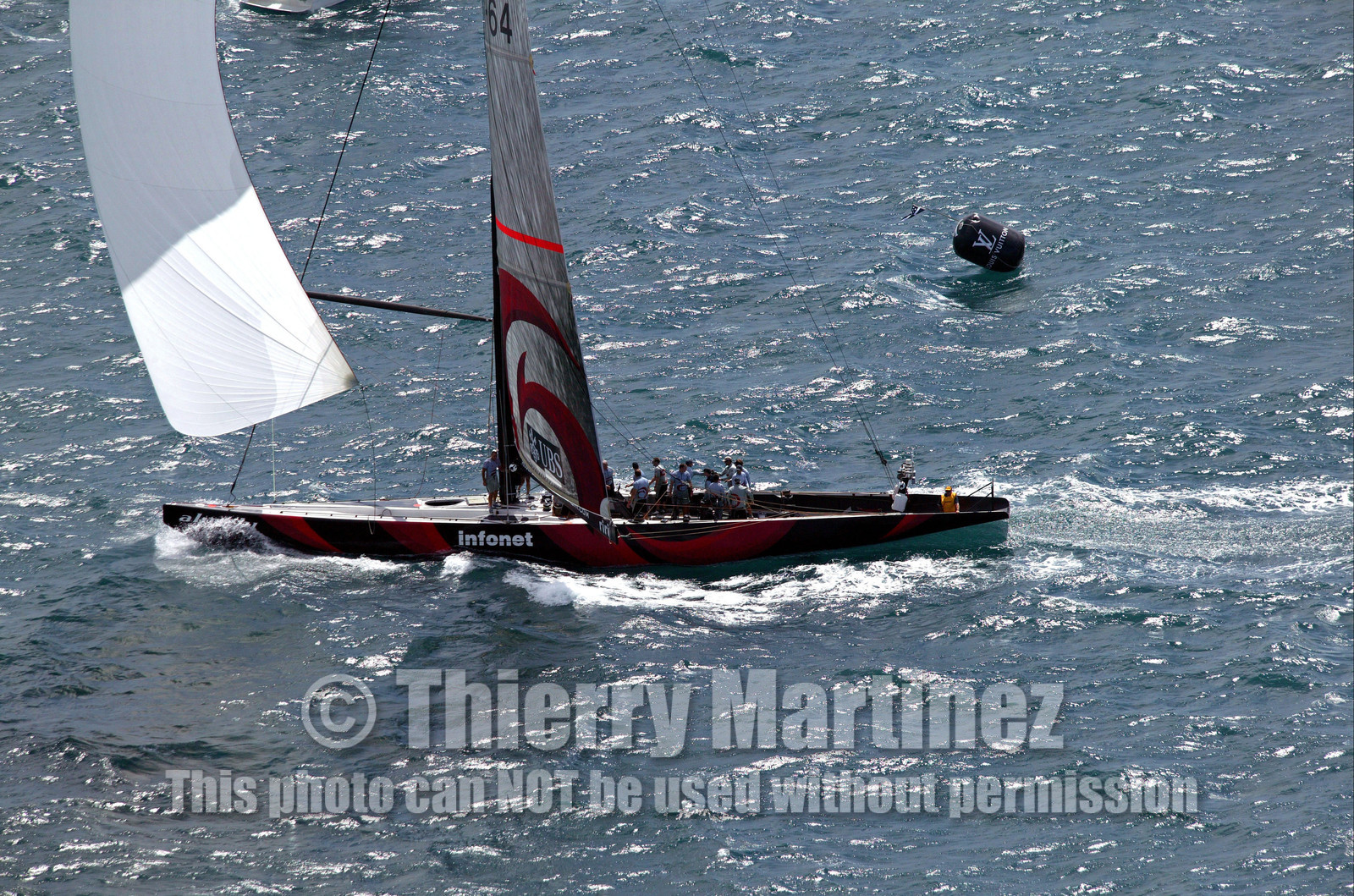 03_0966D © Th.Martinez . Auckland   New Zealand. 18th February 2003 America's Cup 2003, Day 3 Alinghi(SUI64) vs Team New Zealand(NZL82) Alinghi team crossing the finish line in first on race 3