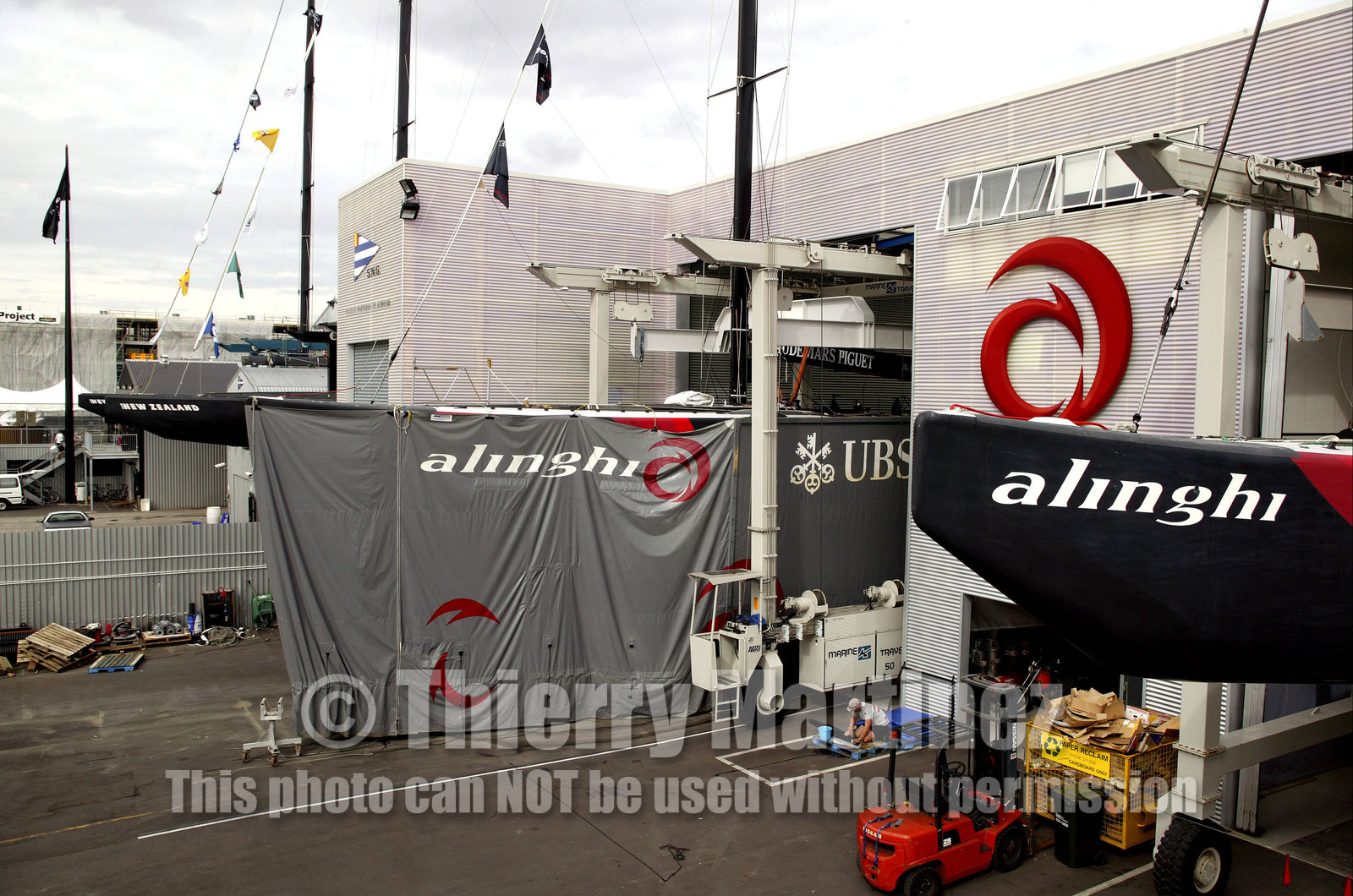 03_1066D © Th.Martinez Auckland   New Zealand. 24th February 2003  America's Cup 2003. Day 4, Race cancelled lack of wind. Alinghi (SUI64) vs Team New Zealand (NZL82)For fourth times in row race day 4 of the America's Cup 2003 have been cancelled. The two race boat have been left in sheds. In foreground SUI 64, SUI 75 with her skirt, and Team NZ 's boats NZL 81 & NZL 82..